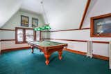 Formerly the ball room, this expansive third-floor space now serves as a carpeted game room. The pool table and an L-shaped LazyBoy couch are included.