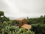 Surrounded by a sea of forest in Northern California, the Portola Valley House features fire-resistant construction. The annex is wrapped with Corten corrugated siding, while shou sugi ban treated timber clads the main house. 