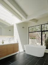 The master bathroom overlooks a private garden. The freestanding tub is by Blu Bathworks and the flooring is slate tile. 