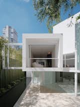 Architect Miguel Angel Aragonés is seen in the cantilevered second-floor bedroom that overlooks the rear courtyard of Rombo IV, one of four structures on his Mexico City property—three houses and a studio—collectively called Los Rombos after their rhomboid shape.
