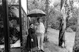 Ray and Charles standing beneath an umbrella next to historic eucalyptus row that dates back to the 1880s and is still standing today. 