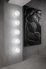 In addition to serving as a restaurant and showroom, The Manzoni can also be used as an art gallery or nightclub. The wall features Tom Dixon's new semitranslucent Opal lights, which are made from tinted white opalescent polycarbonate and include an integrated dimmable custom LED.