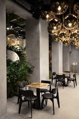 The restaurant pairs new Slab chairs with stone tables by Testi. 