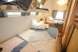 Cables clip onto the ceiling to support an upper bunk, while the bench folds out into a bed. The Airstream can sleep seven comfortably.