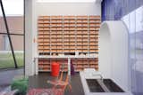 A wall in "Tomorrow" comprises consecutively numbered bright orange Ceramic Blocks that double as storage. 