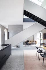 The modern steel staircase adds a striking architectural element to the space and leads from the ground-floor living spaces to the bedrooms upstairs.