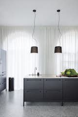 Vipp pendant lamps ($500) are suspended over the sleek and modular Vipp kitchen. The iconic pedal bin occupies a corner. 