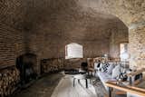Living Room, Chair, Coffee Tables, Sofa, and Wood Burning Fireplace The first-floor den features a wood-burning stove.   Photo 7 of 16 in Own a Brilliantly Converted Brick Fortress in England For $1.5M