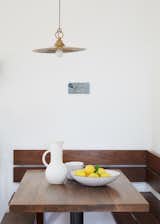 A kitchen nook with Heath Ceramics bowls occupies a corner of the living area. 