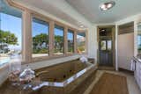 A peek inside the master bath with views of the pool and Santa Barbara.