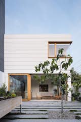 "The custom profile painted siding echoes the typical horizontal lap siding seen throughout the neighborhood while playing with scale," says Ryan. "Also, the extruded white oak window boxes on the new structure give a nod to the more traditional approach to window casings while making them more three dimensional."