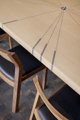 DeForest Architects designed the custom extendable dining table with key compass points set in with metal inlays that point to special places in the owners' lives. William Walker Woodworks built the piece.