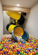 After the clients discovered the location of the slide, they decided to add a ball pit in the basement where the slide empties out. 