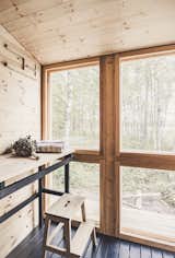 Large windows flood the sauna with natural light and face views of the lake. 
