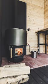 Brick and metal sheeting around the sauna stove provide fire protection. 