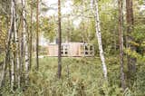 Located in Lavia in southwest Finland with nary a neighbor in sight, the remote cabin is set close to a lake and surrounded by a swamp and an old forest. The site was selected for its lake views and close connection to nature. "On some days you can see moose, deer, and traces of lynx," say the designers, who use the cabin as a retreat from city life. 