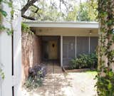 Before: The view from the main entry to the interior entry court and the front door with its original, open-air approach.  Photo 5 of 29 in Before & After: We’re Taking Notes on This Expertly Rehabbed Midcentury in Austin