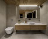 A peek into one of the bathrooms with an aspen slatted ceiling. The bathroom connects directly to the sauna. 