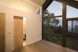 Behind the sliding door is the master bath with a glazed shower with views of the valley below.