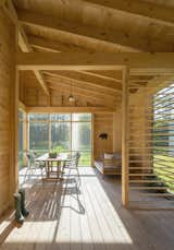 A look inside the post-and-beam screen porch built with locally sourced eastern white pine. The floors are Port Orford cedar. 
