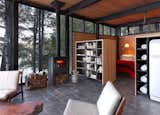 Kawagama Boathouse by Building Arts Architects wood-burning stove in living room