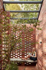 The small outdoor courtyards are surrounded by hit-and-miss brick screens to provide privacy while allowing light and air to flow through. 