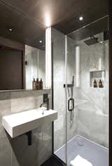 The minimalist bathroom with a walk-in shower is dressed in marble and comes with Molton Brown® toiletries.