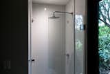 A peek inside the shower, which features Tristone solid surface walls in Snowrange.
