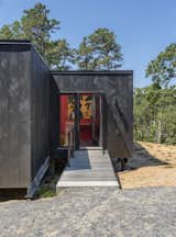At a prefab home in Cape Cod, the client told the architects that she didn’t want any stairs in her new single-story home, which is fitted with an entrance ramp.