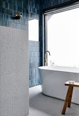 The freestanding bath and shower are located in a "wet room" separate from the toilet, and are fitted with the same tiles found in the kitchen and dining area.