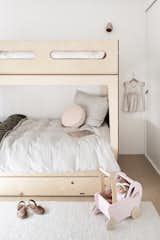 To continue home’s minimalist, Scandinavian-inspired theme, the couple purchased Plyroom bunks for their kids. The bedding is from Society of Wanderers.