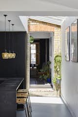 The brick pictured is original to the home. “We wanted to connect our new extension against the retained rear wall of our house as a feature and acknowledgement of the original building,” says Richard. “The doorway/opening is actually the original doorway into our side alleyway and garden—we just removed the doors and tidied up slightly.”