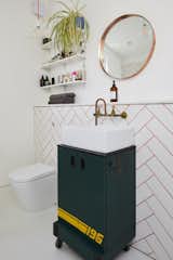 The crafty couple made all of the bathroom's copper fixtures, as well as the mirror. The 196 wheeled cabinet was an eBay find.