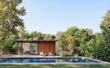 On the site's southwest side, the second canopy structure atop the guest suite features deep overhangs to shelter the pool and lawn from the intense setting sun. 