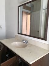 Before: A look at the original vanity, which was ripped out and replaced with a custom wood waterfall vanity.  Photo 9 of 18 in Before & After: A Run-Down Row House in Pennsylvania Gets Adventurous With Color