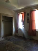 Before: This space on the upper floor was previously a bedroom with two tiny closets that were removed to enlarge the room.  Photo 15 of 18 in Before & After: A Run-Down Row House in Pennsylvania Gets Adventurous With Color