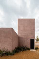 "We wanted to give a natural feeling and some color related to the surrounding earth—but we wanted to have a finish that would age well, so we avoided the use of paint on the outside," explain the architects regarding the home’s pink concrete plaster.