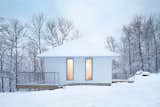 Canadian firm Naturehumaine designed and constructed this 1,250-square-foot, three-bedroom holiday home over the course of two years. The compact and monochrome cabin is oriented to face the lake and slightly angled toward the south to optimize solar gain.&nbsp;