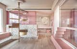 In a seaside holiday home in Taiwan, two goals were the focus of the design: a dominant pink palette, reflecting the homeowner's favorite color, and a feline-friendly interior for her three cats. The pink hues are offset by the easy-to-clean, dynamic terrazzo surfaces, and the pink is given depth and texture thanks to a mineral paint.