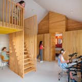 The second children's bedroom features a single elevated loft. The timber storage wall draws the eye upwards.