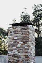The brick vents, openings, and chimney flue are protected from falling embers.