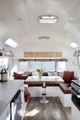 Affectionately named Birdie, the 154-square-foot Airstream was treated to a sleek overhaul with an abundance of storage hidden beneath custom furniture. The convertible dinette, which fits five to seven people, can be transformed into a large family sofa or a queen-size bed.