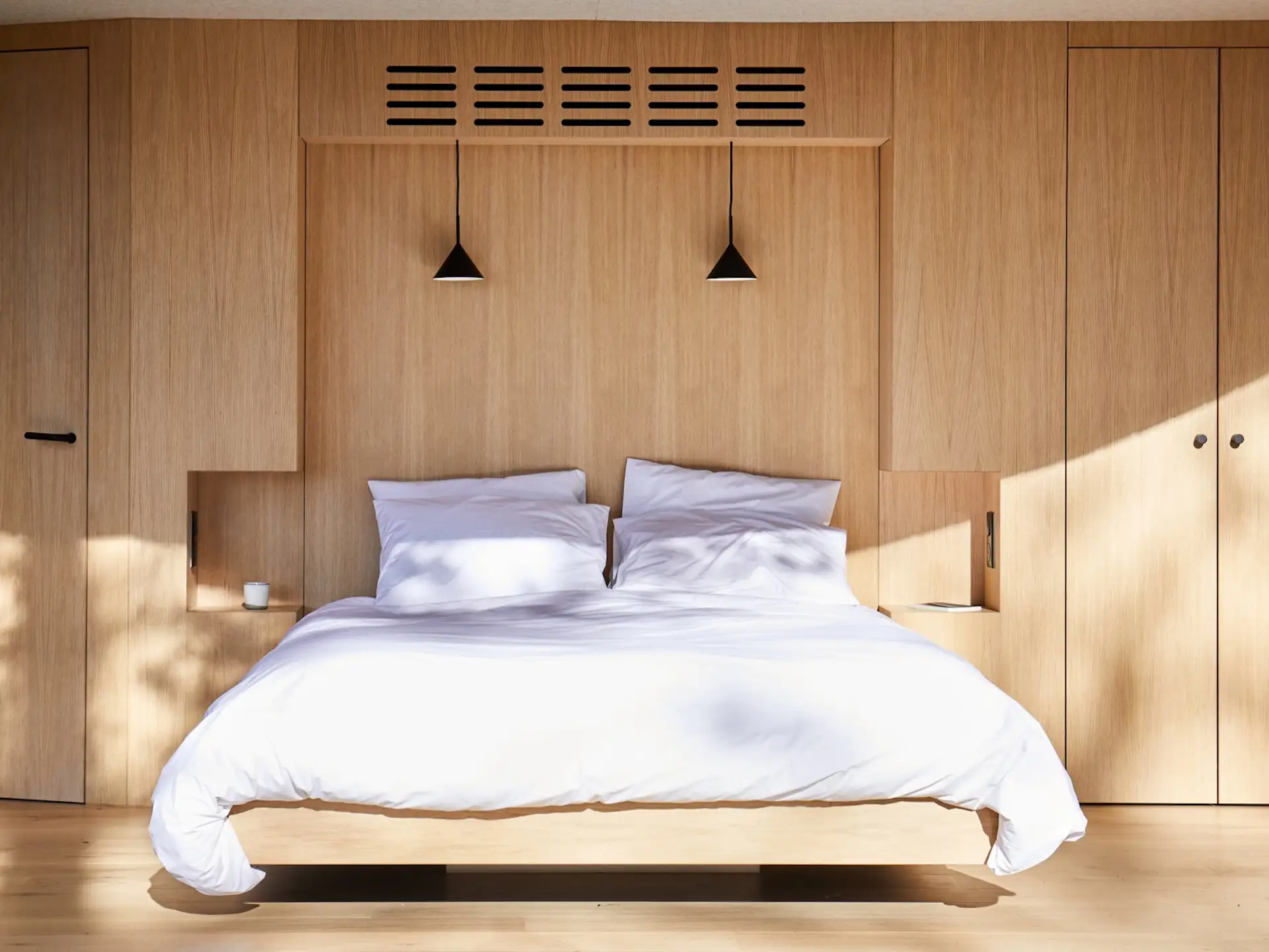 In the Lumipod 5 and Lumipod 6, the elevated bed is positioned for panoramic views of the outdoors, and it’s set into a niche within the built-in cabinetry.
