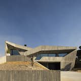A Jagged Concrete Home Emerges From Its Rocky Landscape in Portugal