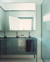 The custom modern steel basin in the kids' bathroom was inspired by schoolyard drinking troughs. 
