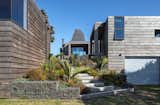 The home is clad in reclaimed, silver-toned swamp totara that helps it blend into the dunes. The textured cladding is mounted on custom Perspex for easy maintenance. 