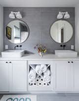 The vanity was installed at the factory, and the mirrors and lights were added on-site. 