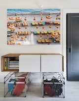 An aerial photo of a beach hangs above a wall-mounted 3X shelf by LAXseries.