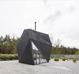 The architects sprayed a graphite polyurethane  coating onto the steel structure to achieve an origami-inspired "visually light, paper form". 