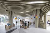 Undulating ribbed ceilings made of plywood add a sense of play to the interiors. 